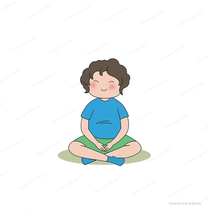 Boy sitting cross-legged on grass meditating with his eyes closed