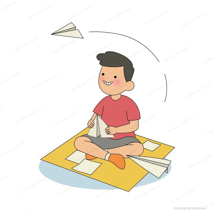 Boy sitting cross-legged on a mat folding paper planes and launching one into the air