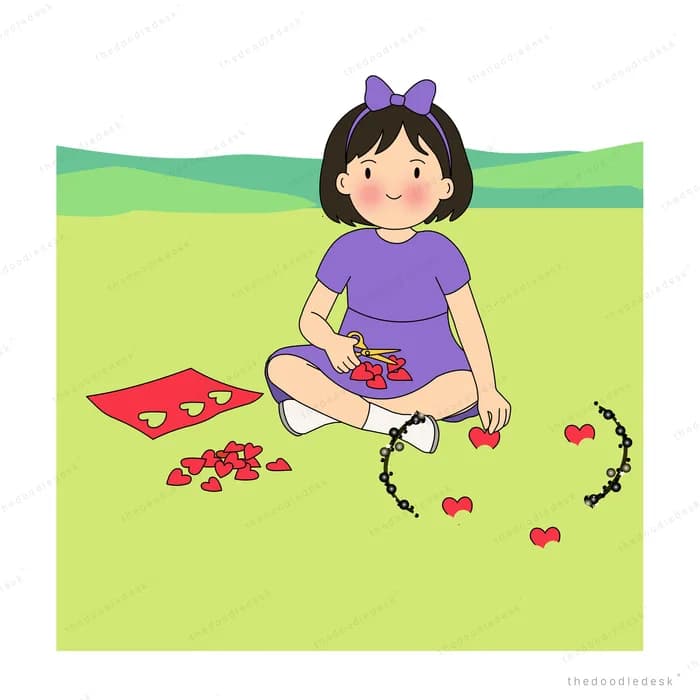 Girl making a red flower garland on a bright green lawn