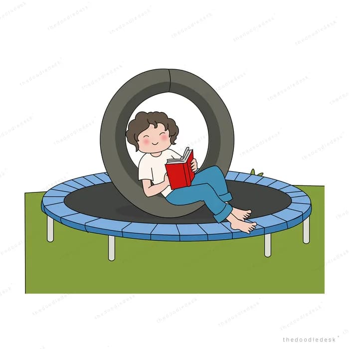 Boy lying on a blue trampoline reading a red book with a tyre swing above
