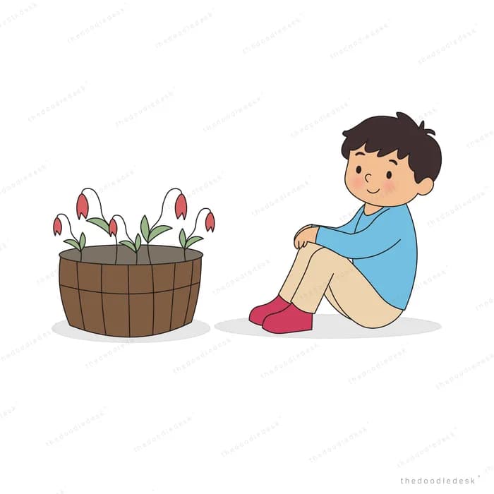 Boy sitting hugging his knees next to a wooden tub of tulips