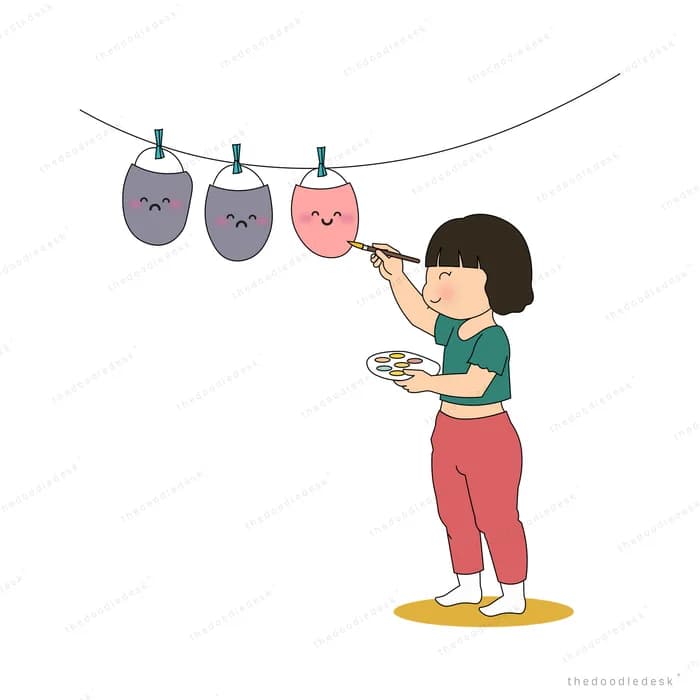 Girl painting a smile onto sad faces pegged along a washing line