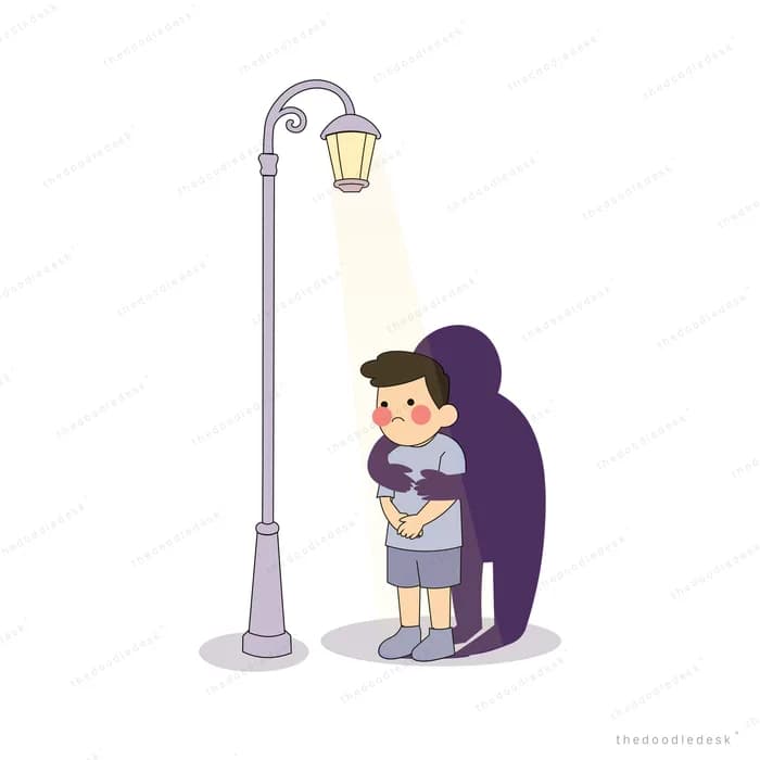 Boy standing under a street lamp casting a large dark shadow behind him