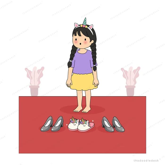 Girl on a red mat looking down at pairs of shoes laid out around her