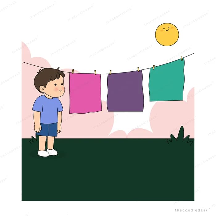 Boy hanging bright laundry on a clothesline under a smiling sun