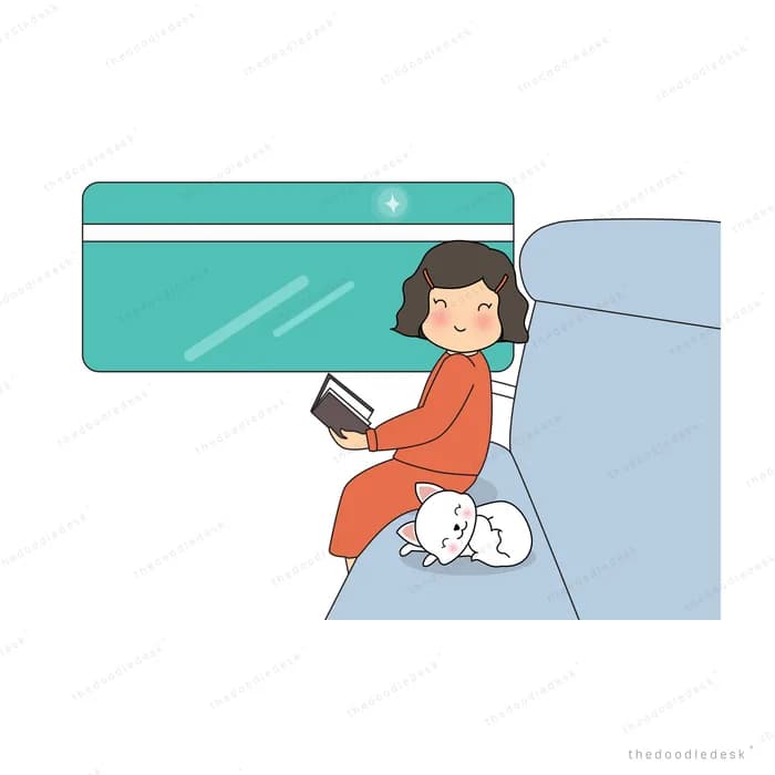 Woman reading in bed with a cat at her feet