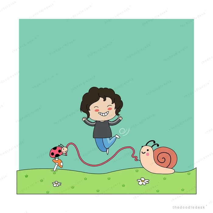 Boy skipping rope beside a snail on grass