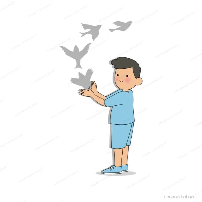 Boy opening his hands to let a flock of grey birds fly up and away