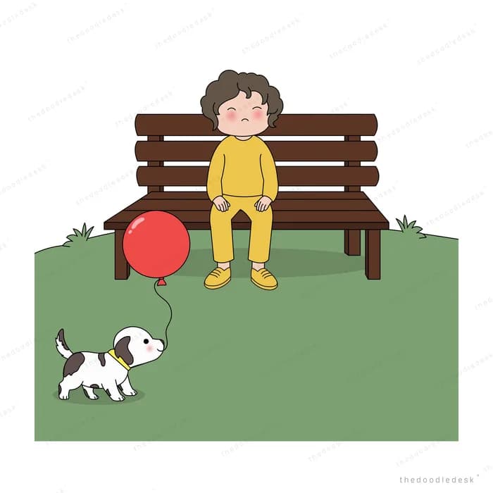 Boy on a park bench as a spotted dog brings him a red balloon
