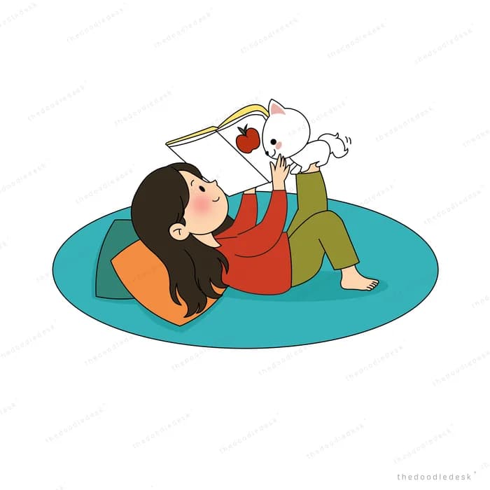 White puppy landing on the open book a woman is reading while lying on a rug